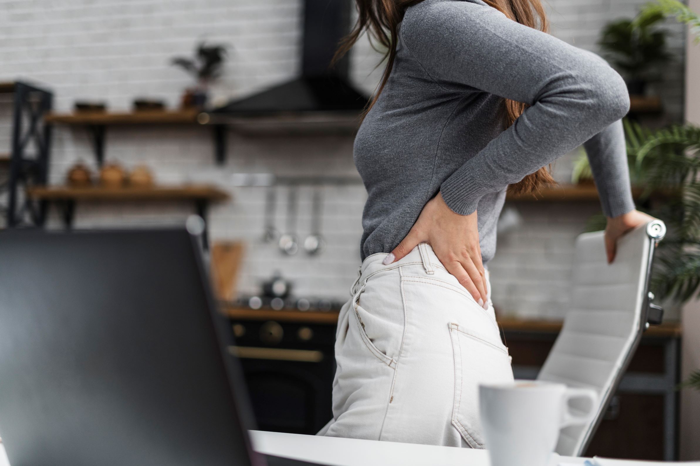 woman with back pain going down leg